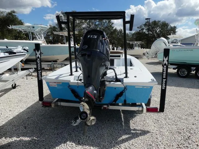 Slide: The Image of 2025 Xpress Boats Skiff 185 with outboard motor, displayed on gravel lot. - 6
