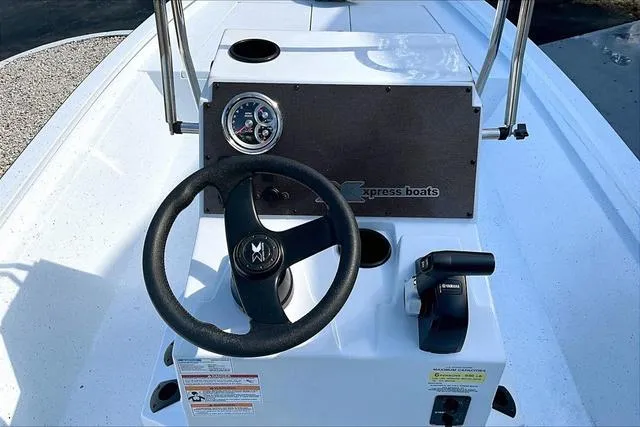 Slide: The Image of 2025 Xpress Boats H210 BAY steering console with controls and gauge. - 10