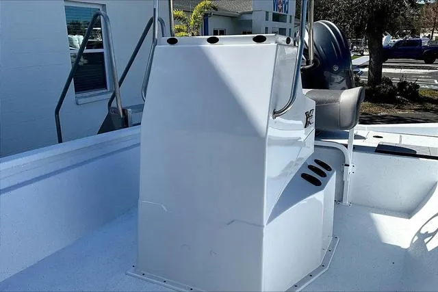Slide: The Image of 2025 Xpress Boats H210 BAY console and seating area in a sunny outdoor setting. - 13