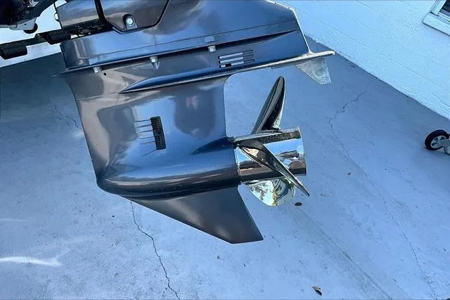 Slide: The Image of 2025 Xpress Boats H210 BAY outboard motor propeller on concrete surface. - 20