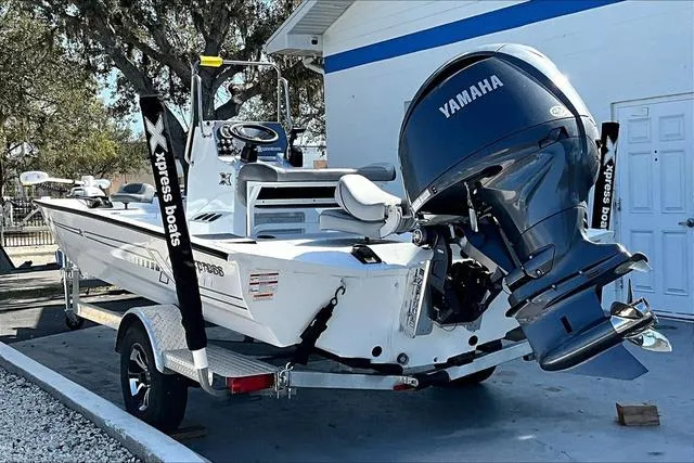 Slide: The Image of 2025 Xpress Boats H210 BAY with Yamaha engine, parked on a trailer. - 4