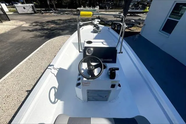 Slide: The Image of 2025 Xpress Boats H210 BAY, top view of steering console and deck. - 7