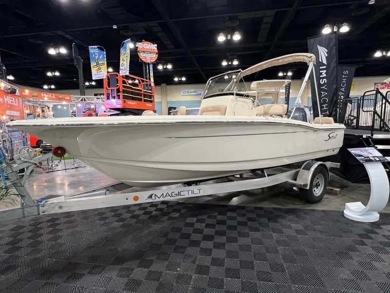 The Image of 2025 Scout 195 Sportfish boat displayed on trailer at indoor exhibition. - 0