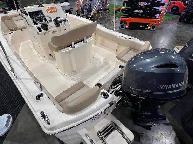 Slide: The Image of 2025 Scout 195 Sportfish boat with Yamaha outboard motor, showcased indoors. - 3