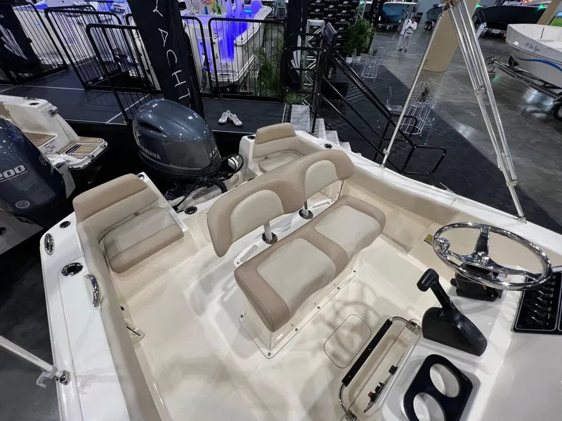 Slide: The Image of 2025 Scout 195 Sportfish boat interior with seating and steering wheel. - 6