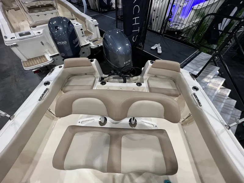 Slide: The Image of 2025 Scout 195 Sportfish boat interior with dual outboard motors, beige seating, and spacious layout. - 9