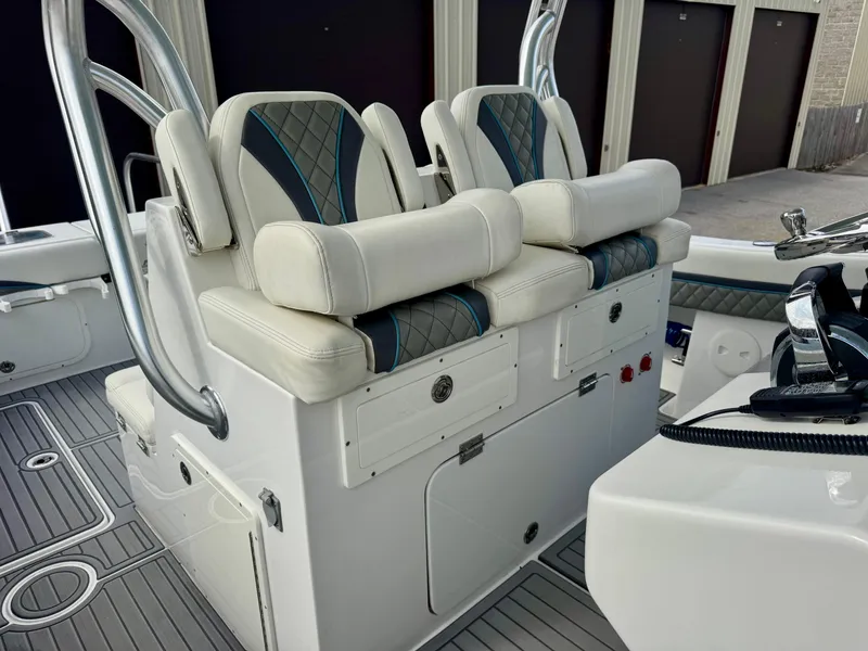 Slide: The Image of 2021 Prowler 31 boat interior with cushioned seating and storage compartments. - 17