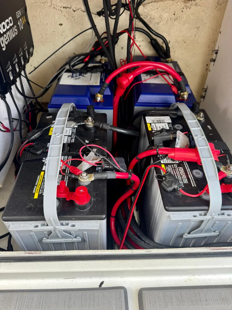 Slide: The Image of Battery setup in a 2021 Prowler 31 RV with red and black cables. - 18