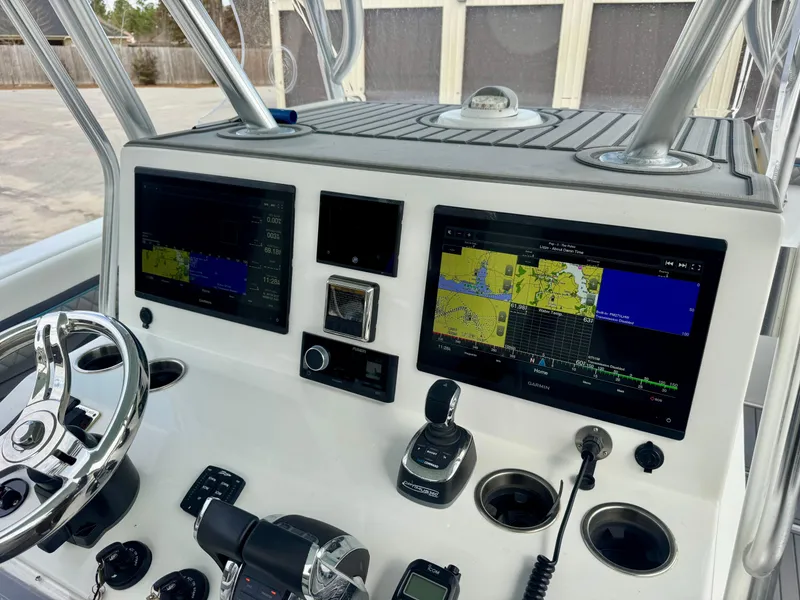 Slide: The Image of Control panel of 2021 Prowler 31 boat with navigation screens and steering wheel. - 21