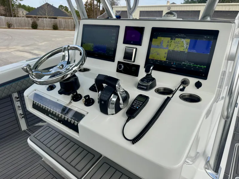 Slide: The Image of Control panel of 2021 Prowler 31 boat with navigation screens and steering wheel. - 22