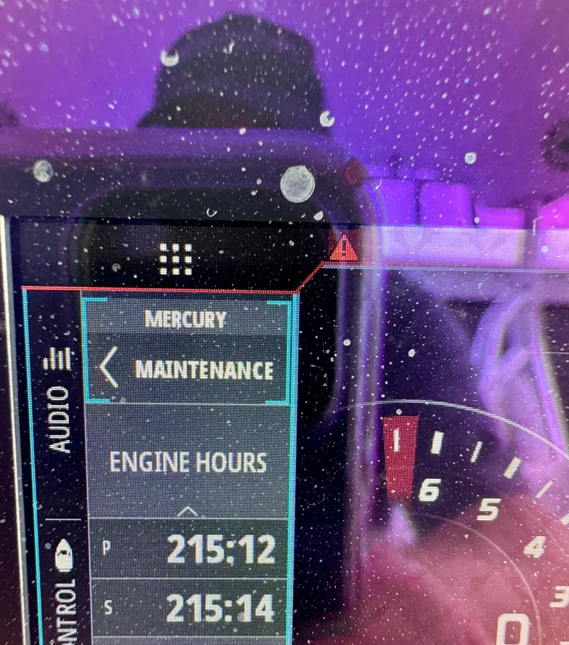 Slide: The Image of Dashboard display showing maintenance alert and engine hours on a 2021 Prowler 31. - 25