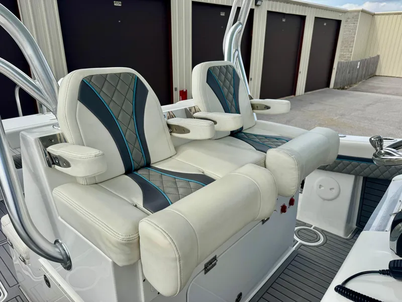 Slide: The Image of Luxury seating on 2021 Prowler 31 boat, featuring stylish upholstery and armrests. - 26