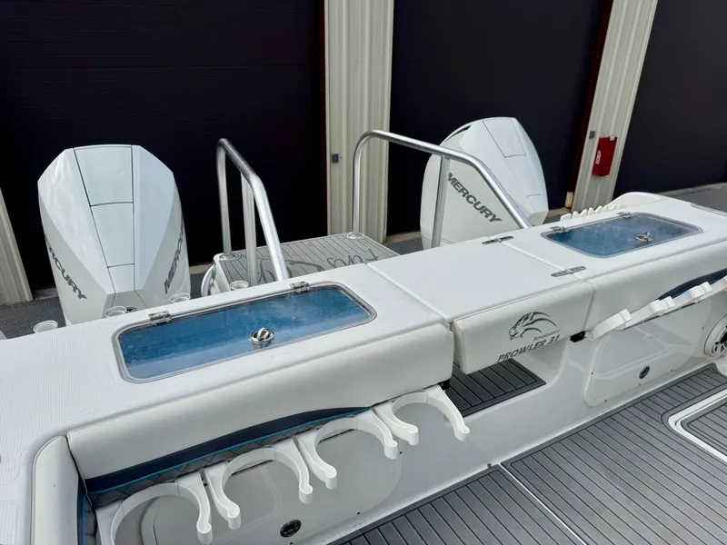 Slide: The Image of 2021 Prowler 31 boat with dual Mercury engines and fishing rod holders. - 27
