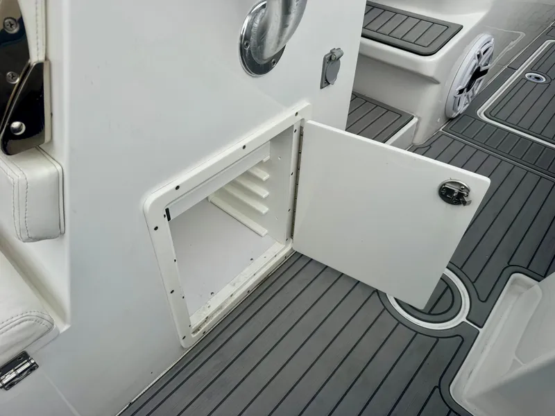 Slide: The Image of Open storage compartment on 2021 Prowler 31 boat with sleek gray flooring. - 29