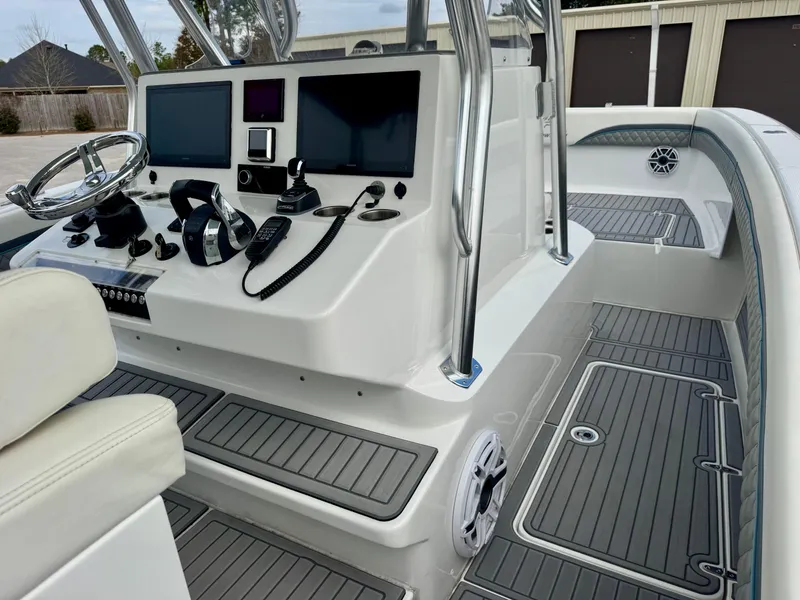 Slide: The Image of 2021 Prowler 31 boat cockpit with modern controls and dual screens. - 30