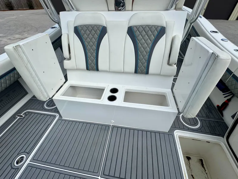 Slide: The Image of 2021 Prowler 31 boat seating with storage compartments and cup holders. - 35