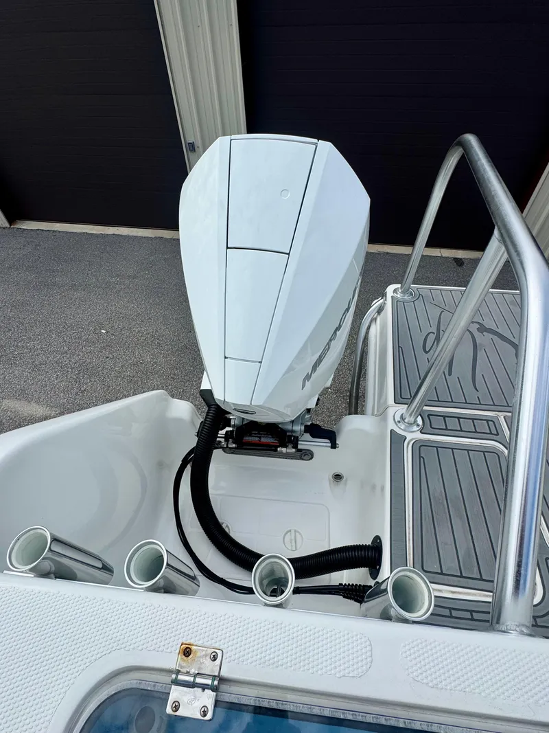 Slide: The Image of 2021 Prowler 31 boat engine and deck with rod holders and ladder. - 37