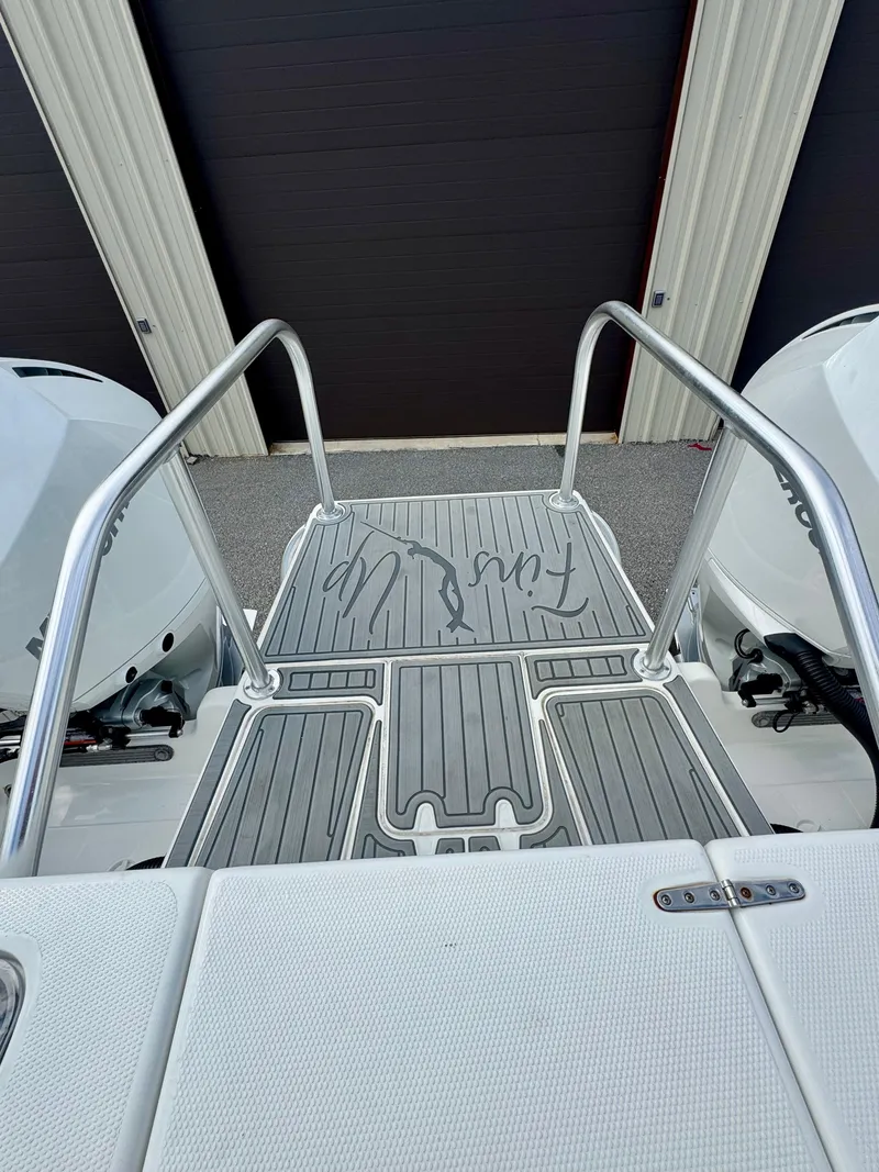 Slide: The Image of 2021 Prowler 31 boat deck with dual engines and metal railings. - 38