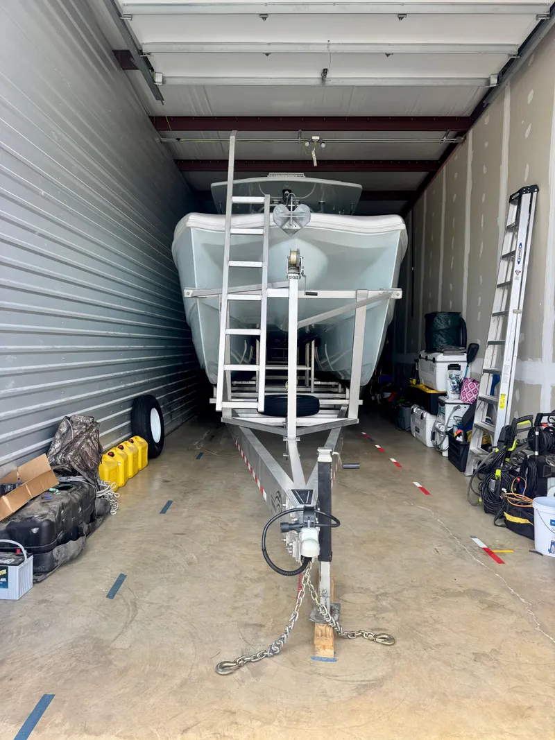 Slide: The Image of 2021 Prowler 31 boat stored in a garage with equipment and supplies. - 40