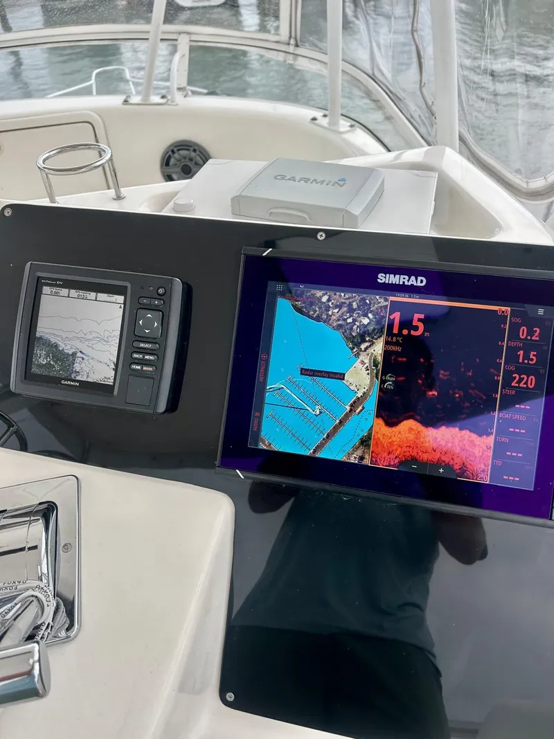 Slide: The Image of Boat dashboard with navigation screens on a 2002 Riviera Convertible 37. - 11
