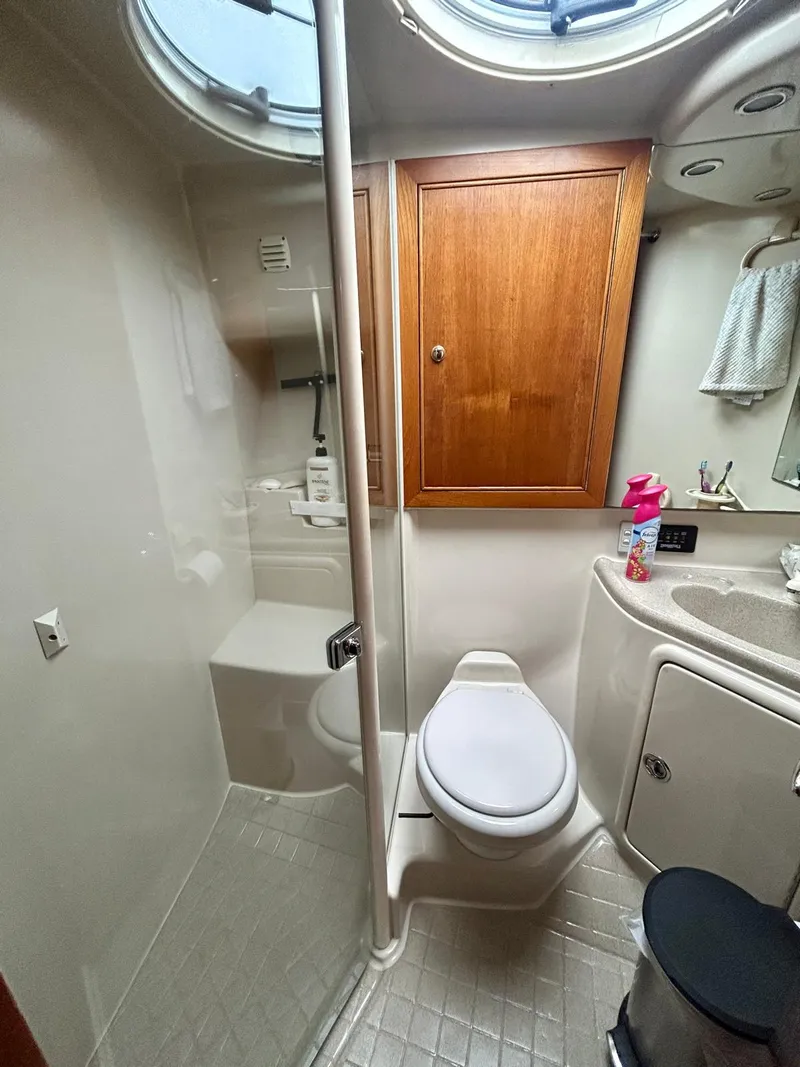 Slide: The Image of Luxurious bathroom in 2002 Riviera Convertible 37 yacht with shower, toilet, and wooden cabinet. - 12