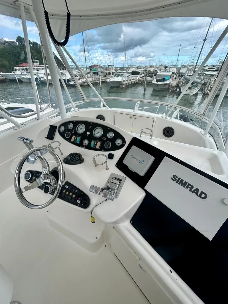 Slide: The Image of 2002 Riviera Convertible 37 yacht helm with Simrad navigation, docked at marina. - 14