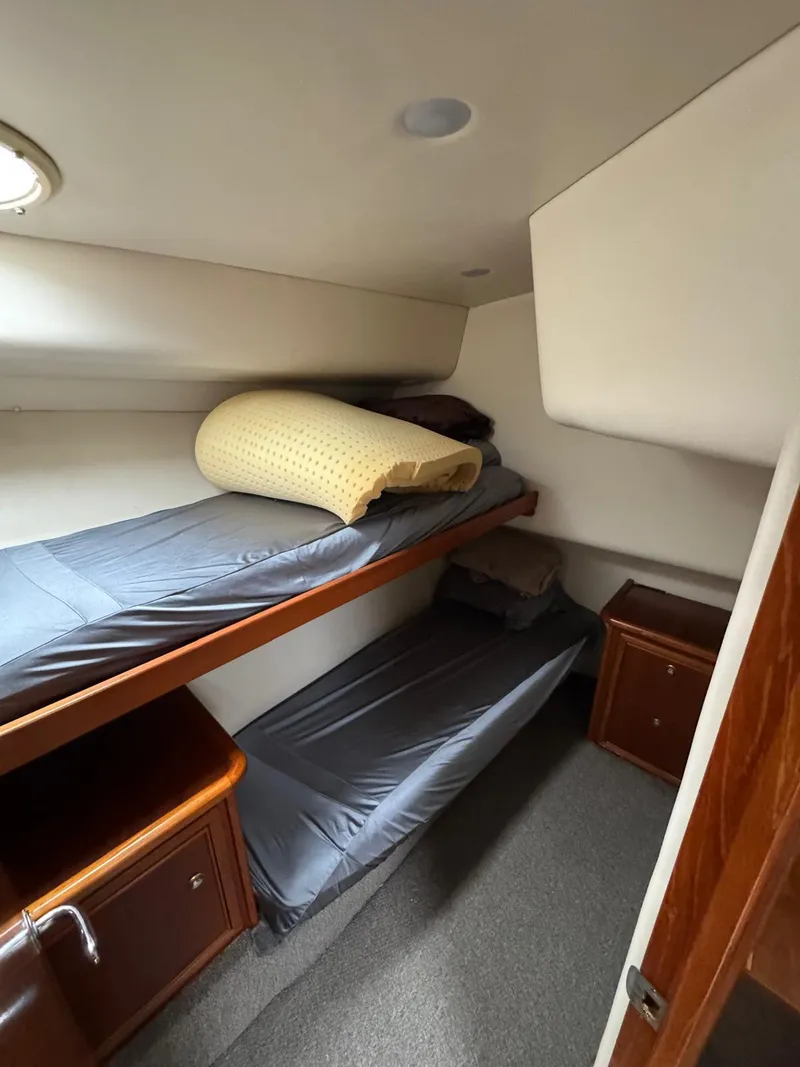 Slide: The Image of Interior of 2002 Riviera Convertible 37 with bunk beds and wooden cabinetry. - 18