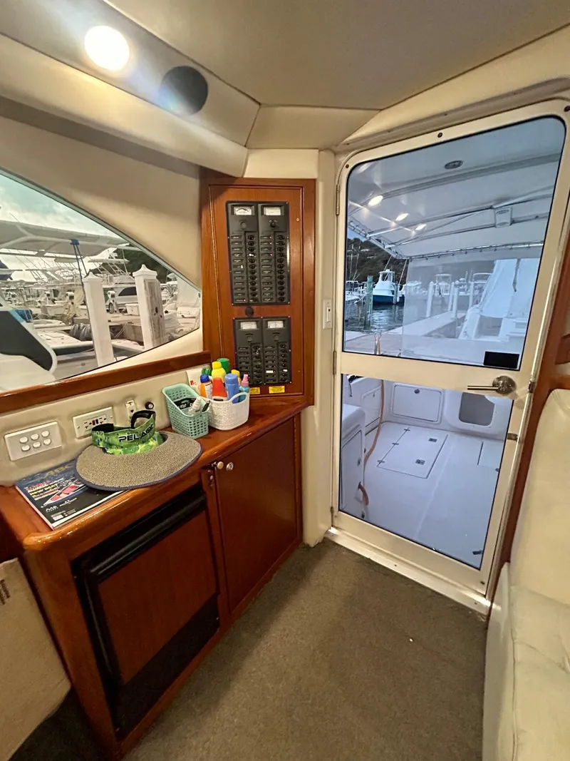 Slide: The Image of Interior of 2002 Riviera Convertible 37 yacht with control panel and door to deck. - 6