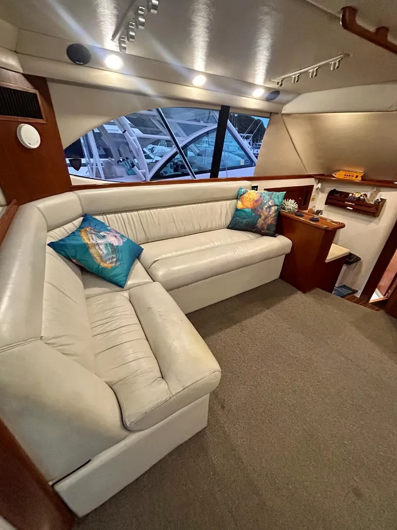 Slide: The Image of Luxurious interior of 2002 Riviera Convertible 37 yacht with plush seating and vibrant cushions. - 7