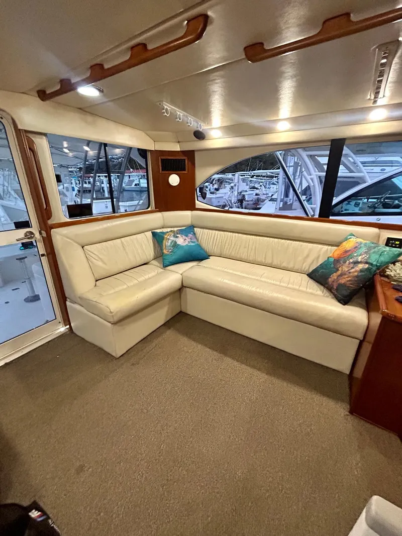 Slide: The Image of Luxurious interior of a 2002 Riviera Convertible 37 yacht with plush seating and decorative pillows. - 8