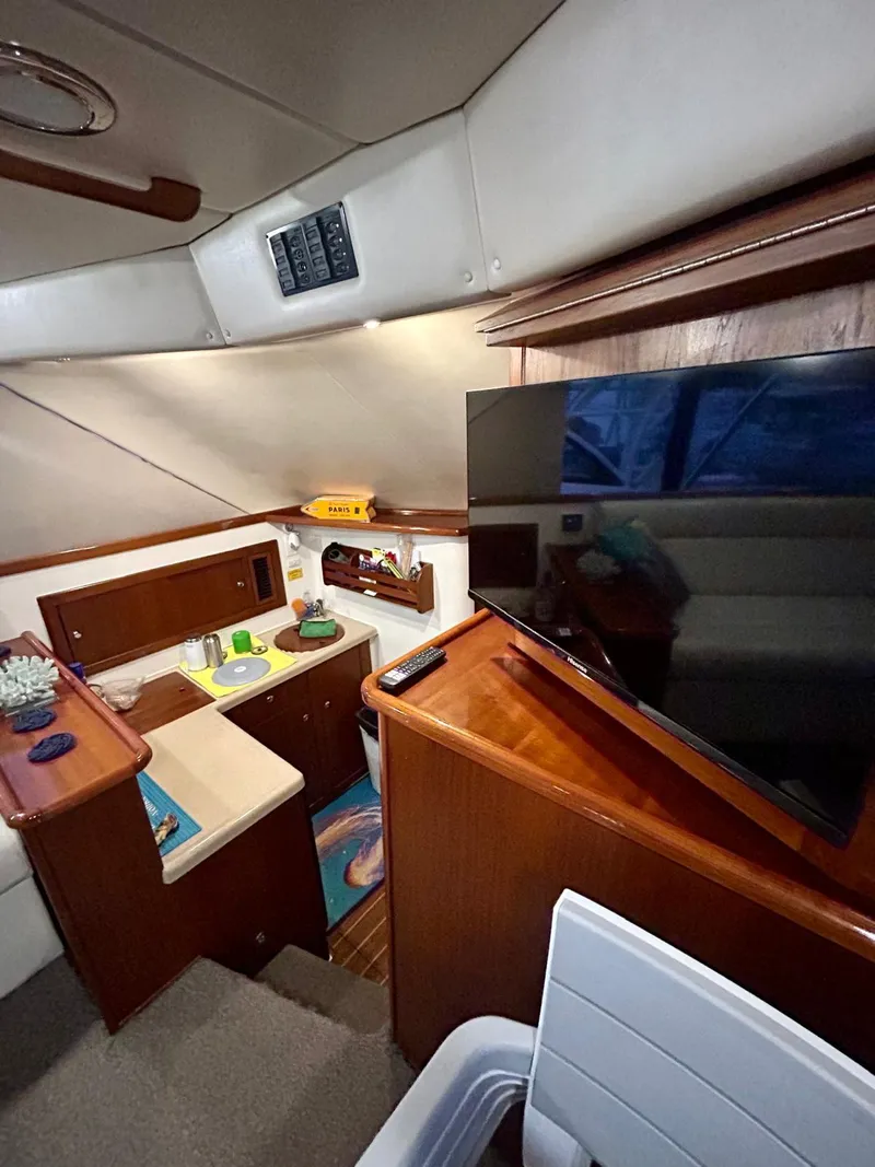Slide: The Image of Interior of 2002 Riviera Convertible 37 yacht with modern amenities and cozy design. - 9