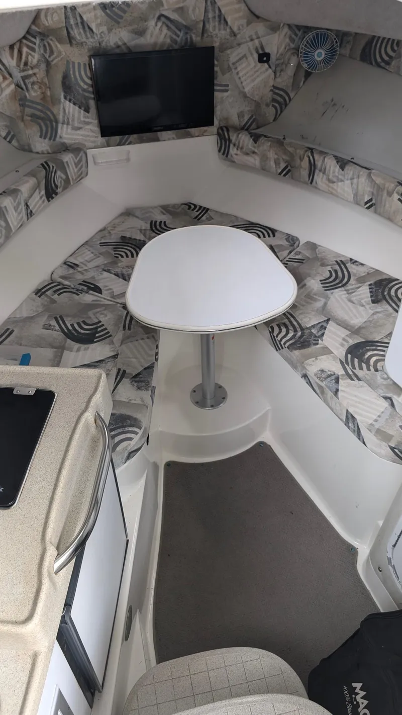 Slide: The Image of 2001 Wellcraft 270 Coastal O/B cabin interior with seating and table. - 10
