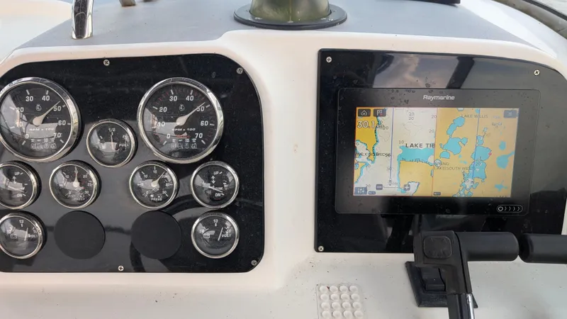 Slide: The Image of Dashboard of a 2001 Wellcraft 270 Coastal O/B boat with gauges and navigation screen. - 15