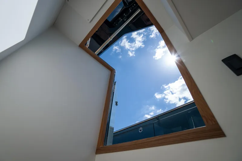 Slide: The Image of Open hatch view on 2025 Pardo Yachts P50, showcasing blue sky and sunlight. - 31