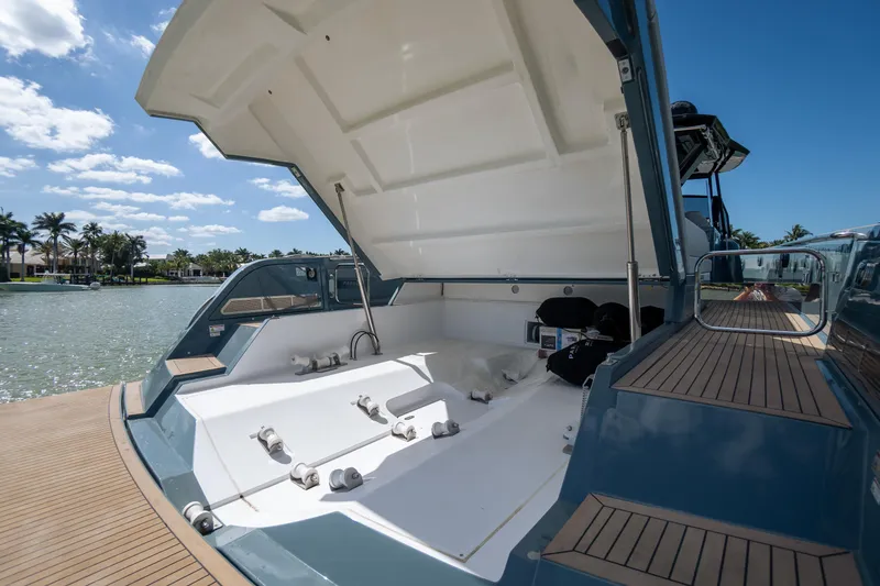 Slide: The Image of 2025 Pardo Yachts P50 with open deck, docked by a scenic waterfront. - 21