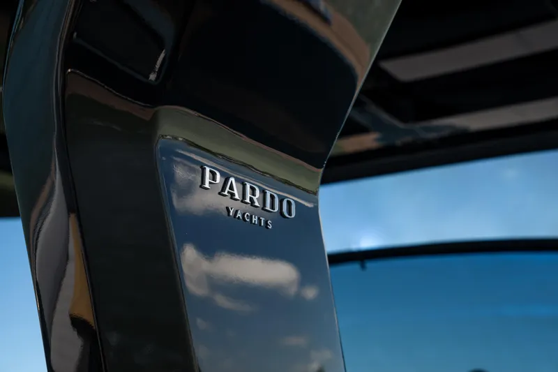 Slide: The Image of 2025 Pardo Yachts P50 logo on sleek black surface with blue sky reflection. - 26
