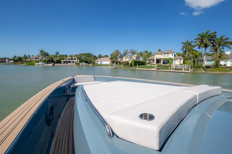 Slide: The Image of 2025 Pardo Yachts P50 on serene waterway with luxurious deck and waterfront homes. - 49