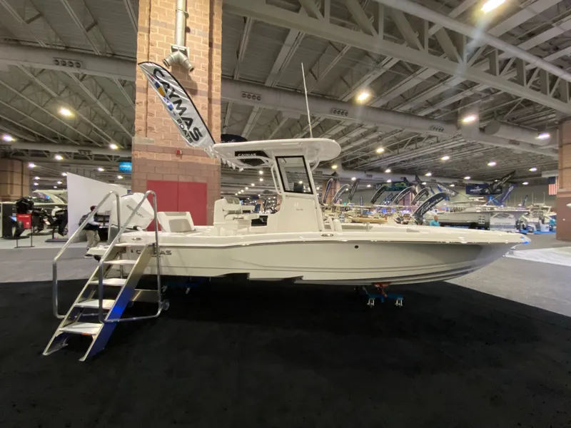 Slide: The Image of 2025 Caymas 26 HB boat displayed indoors at a boat show. - 3