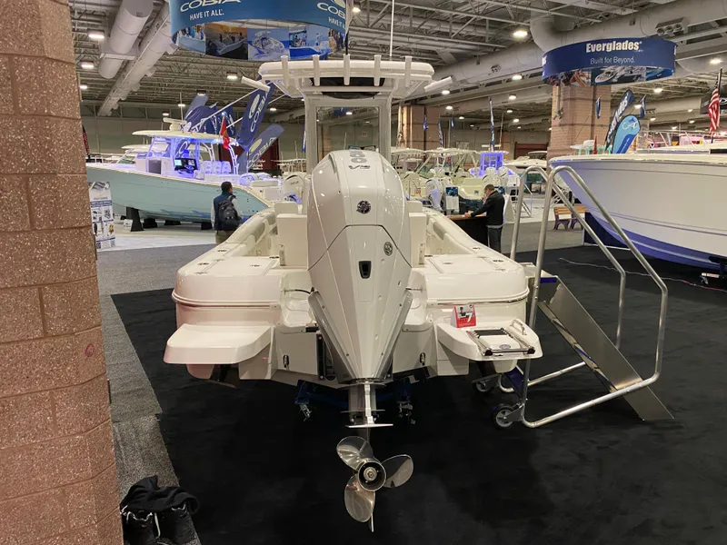 Slide: The Image of 2025 Caymas 26 HB boat displayed at an indoor boat show. - 4