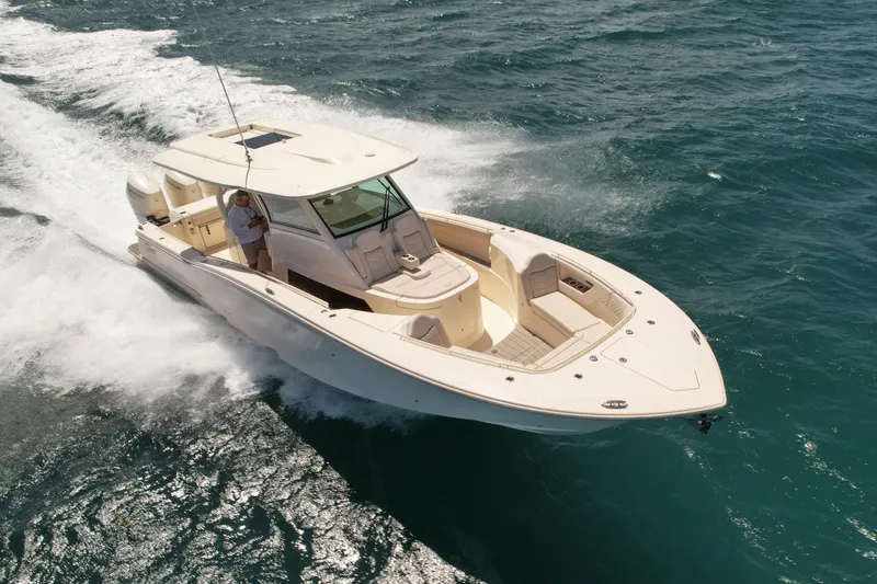 The Image of 2024 Scout 377 LXF boat cruising on open water, showcasing sleek design and powerful performance. - 0
