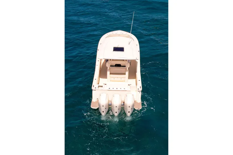 Slide: The Image of 2024 Scout 377 LXF boat on open water, rear view. - 16
