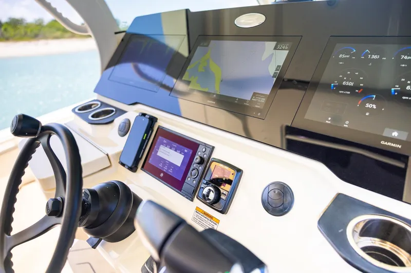 Slide: The Image of 2024 Scout 377 LXF boat dashboard with advanced navigation and control systems. - 20