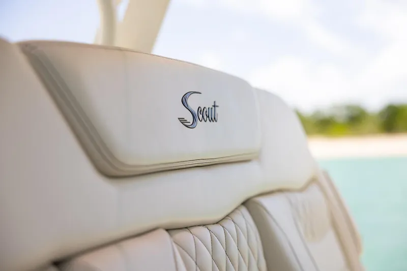 Slide: The Image of 2024 Scout 377 LXF boat seat with logo, featuring luxurious beige upholstery. - 22