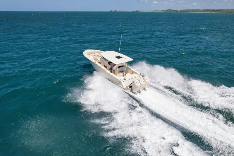 Slide: The Image of 2024 Scout 377 LXF boat cruising on open ocean waters. - 3