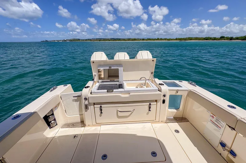 Slide: The Image of 2024 Scout 377 LXF boat deck with sink and storage, ocean view. - 30
