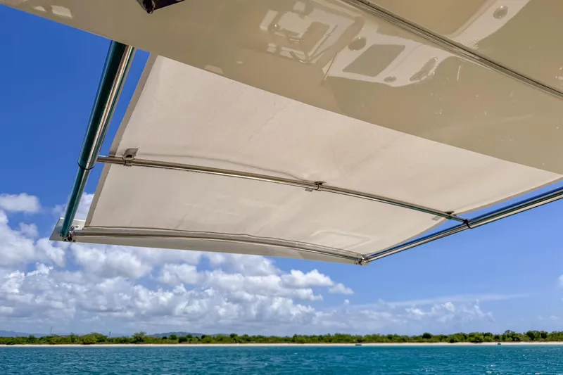 Slide: The Image of 2024 Scout 377 LXF boat canopy with ocean and sky background. - 32
