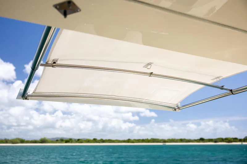 Slide: The Image of 2024 Scout 377 LXF boat canopy with ocean and sky background. - 34
