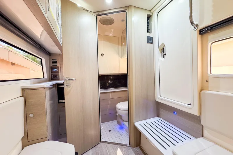 Slide: The Image of 2024 Scout 377 LXF interior cabin with modern bathroom and seating area. - 39