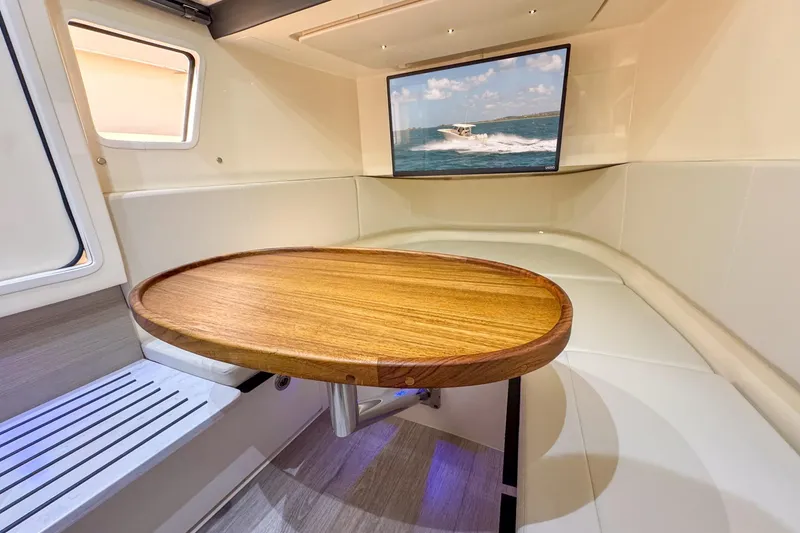 Slide: The Image of 2024 Scout 377 LXF cabin interior with wooden table and wall-mounted screen. - 41