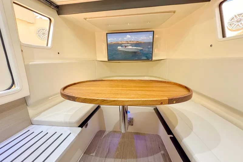 Slide: The Image of 2024 Scout 377 LXF interior with wooden table and cushioned seating. - 43